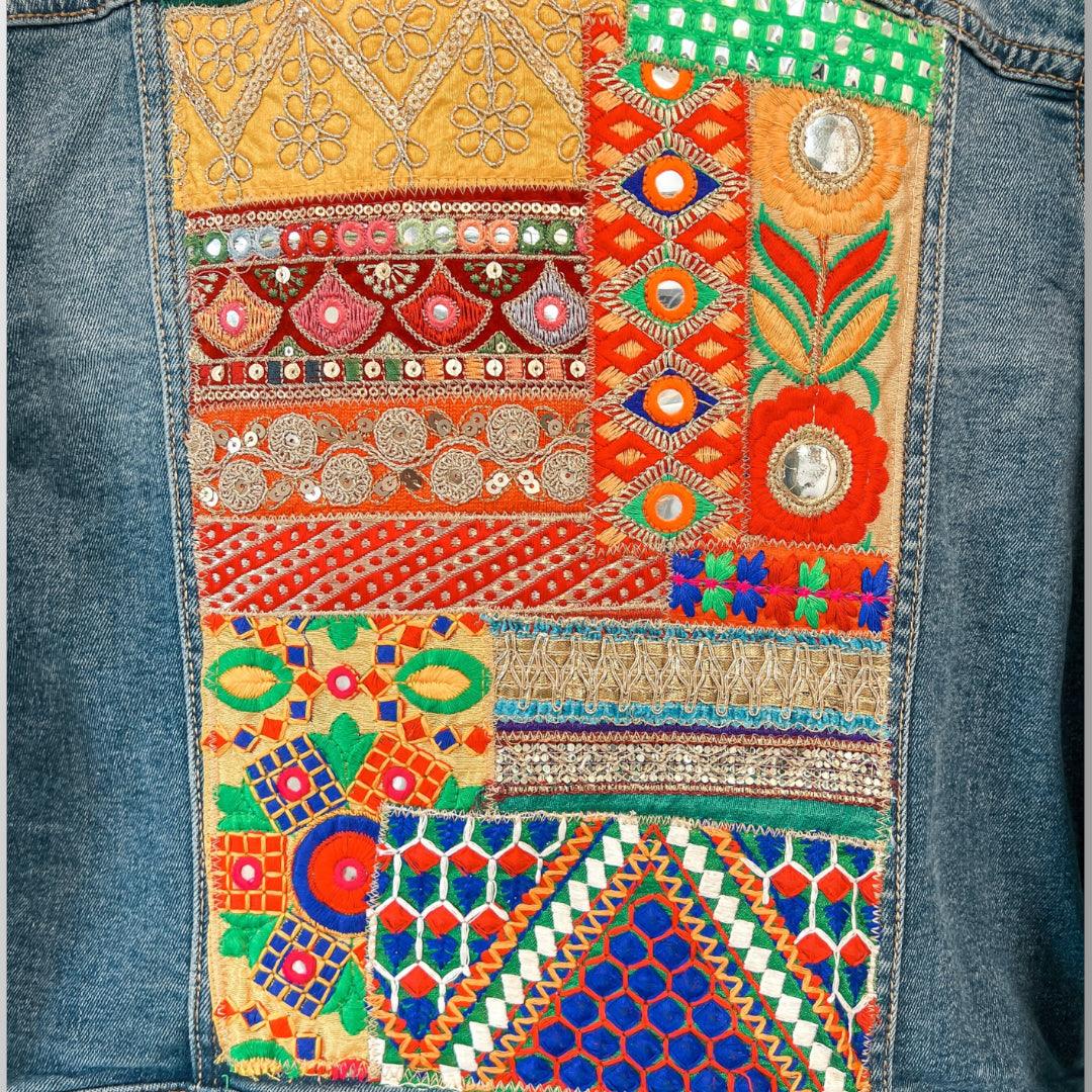 Upcycle embellished jean jacket is hand designed from a repurposed jean jacket and sari scrap fabrics from India. Sari Patchwork on back.