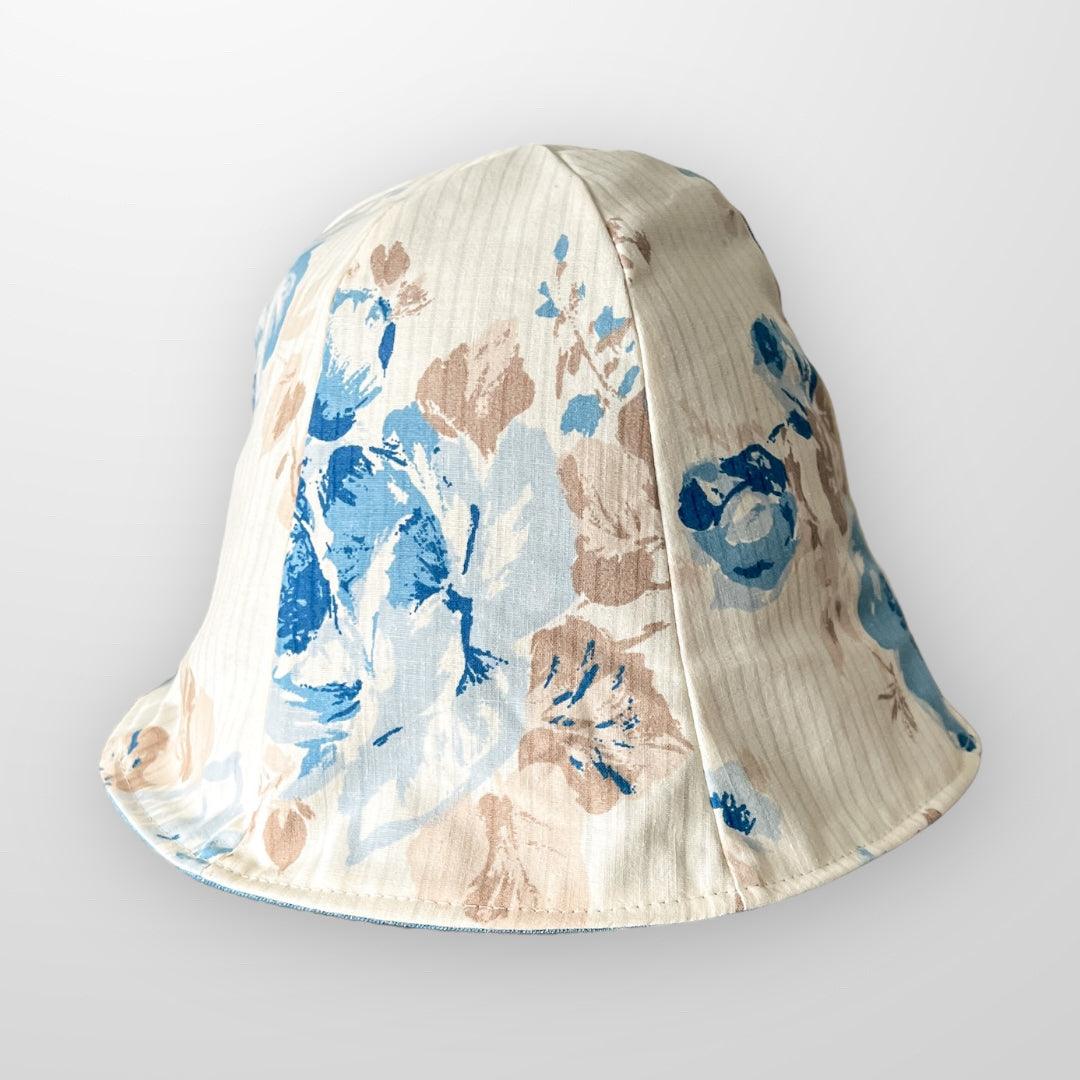 Upcycled sun hat blue and beige with removeable scrap fabric flower pin. Reversible and foldable.
