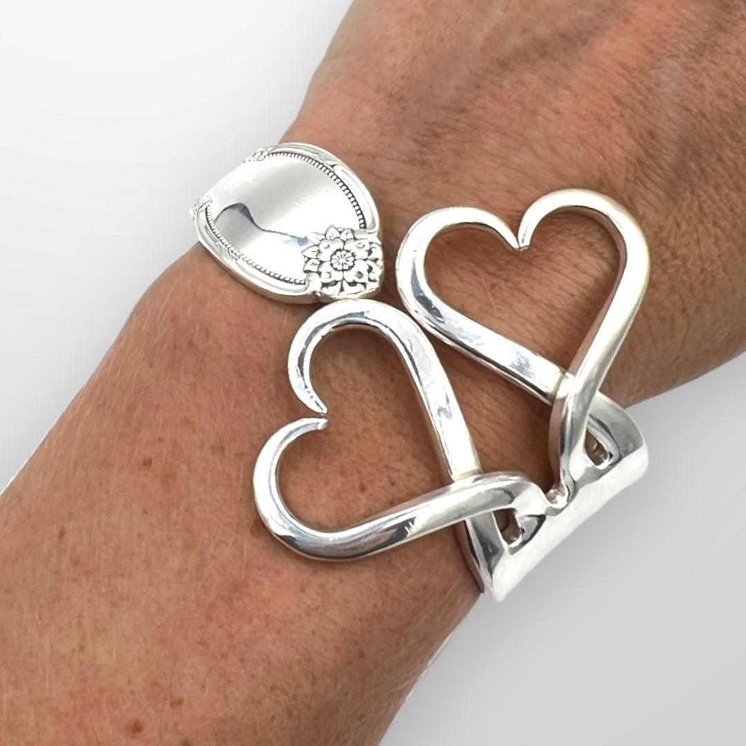 Upcycle Double Heart Fork Bracelet from vintage silver. Size large plated cutlery. Size medium. Displayed on wrist.