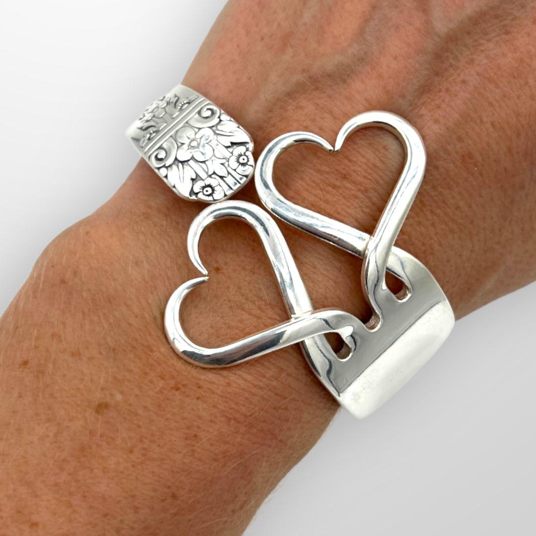 Upcycle Double Heart Fork Bracelet from vintage silver plated cutlery. Size large. Displayed on wrist.