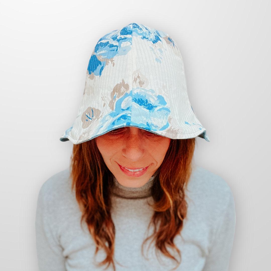 Upcycle Bucket Hat blue and beige with removeable scrap fabric flower pin. Reversible and eco friendly. Small.