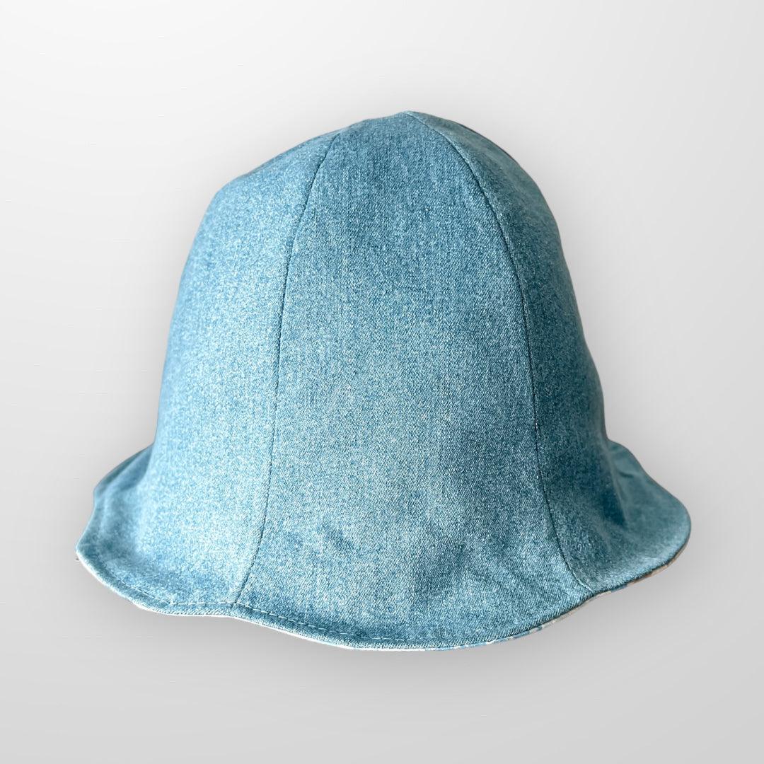 Upcycle Bucket Hat blue and beige with removeable scrap fabric flower pin. Reversible and eco friendly. Small.